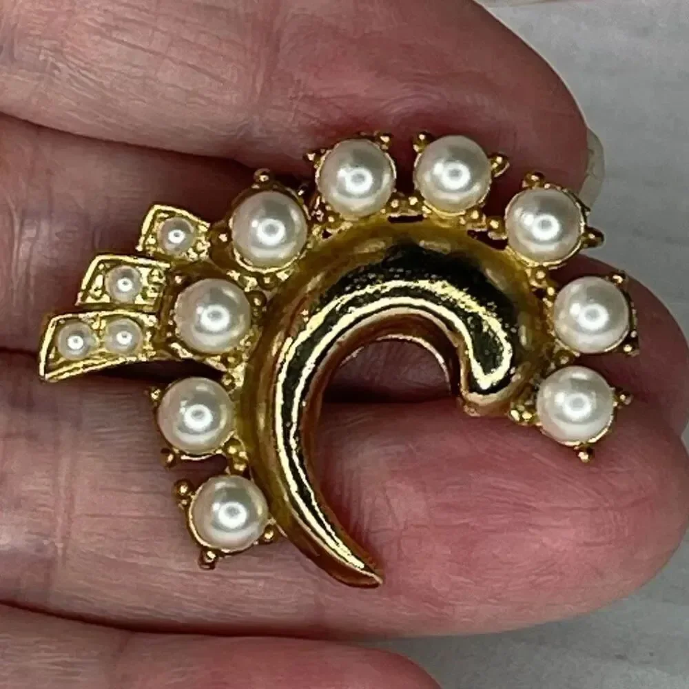 Vintage faux pearl crescent brooch with a small cluster tail accent.